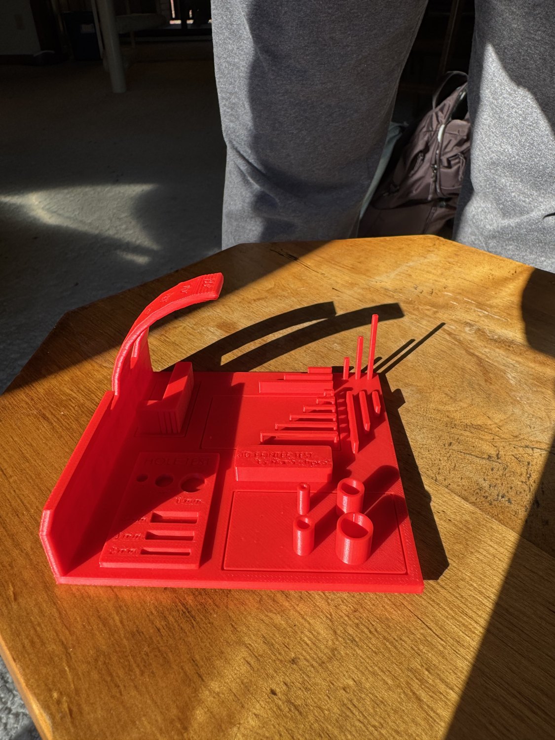 Angled view of the red printer test showing tall columns and curved overhangs
